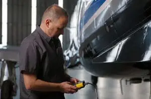 Aircraft technician using the HHMPI for maintenance, showcasing its intuitive design and ease of use."
